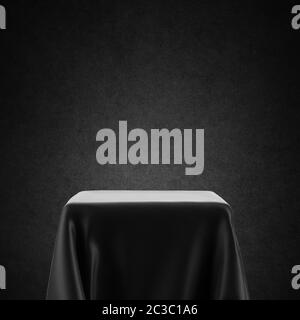 Black and white empty table, spotlight pedestal covered with cloth isolated on backlit background Stock Photo