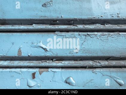 Background of old metal sheet with peel paint texture surface. Painted metal roller shutters door with peeling paint dirty hue. Grungy background text Stock Photo