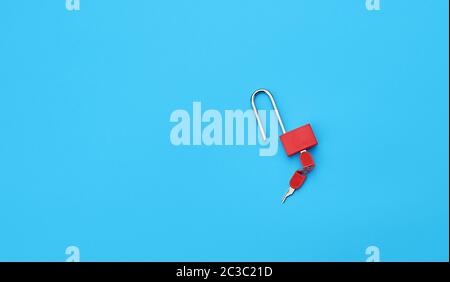 metal open padlock with keys on a blue background, copy space Stock Photo