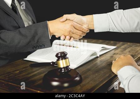 judge and client shaking hands in background at courtroom after good cooperation having meeting or give legal advice attorneys discussing a contract a Stock Photo