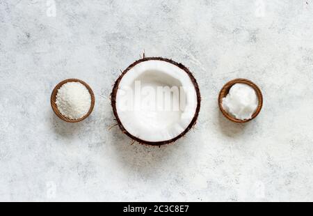 Coconut oil and flour in bowls with a half of coconut top view Stock Photo