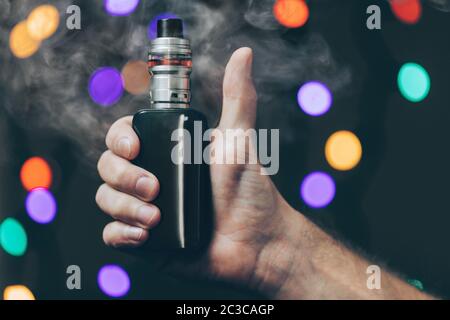 Vaping flavored e-liquid from an electronic cigarette Stock Photo