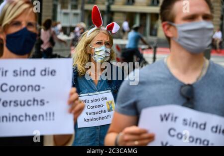 19 June 2020, Hessen, Frankfurt/Main: Primary school teachers hold slips of paper with the inscription 'We are the Corona guinea pigs' in their hands. The Union for Education and Science (GEW) is holding a rally against planned school openings in Hesse. The motto of the protest is 'We are not available as guinea pigs'. Photo: Andreas Arnold/dpa Stock Photo