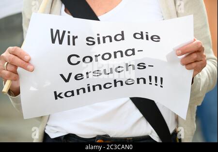 19 June 2020, Hessen, Frankfurt/Main: A teacher holds a note in her hands with the inscription 'We are the Corona guinea pigs'. The Union for Education and Science (GEW) is holding a rally against planned school openings in Hesse. The motto of the protest is 'We are not available as guinea pigs'. Photo: Andreas Arnold/dpa Stock Photo