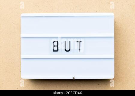 White lightbox with word but on wood background Stock Photo