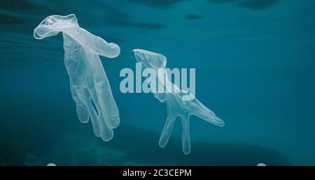 Disposable transparent gloves underwater, plastic waste in the sea since coronavirus COVID-19 pandemic Stock Photo