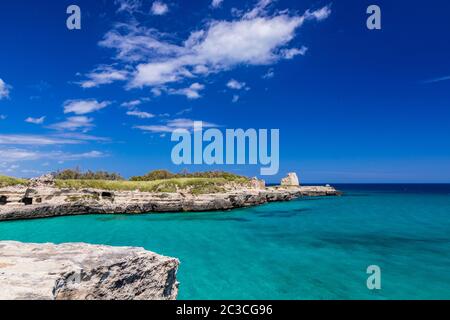 The important archaeological site and tourist resort of Roca Vecchia, Puglia, Salento, Italy. Turquoise sea, clear blue sky, rocks, sun, lush vegetati Stock Photo