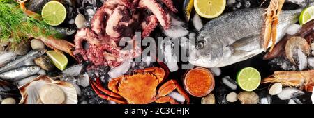 Seafood panorama, shot from above. Fish and octopus, scallop, crab, caviar. Gourmet products flat lay Stock Photo