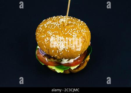 Fresh tasty burger on black background front views Stock Photo