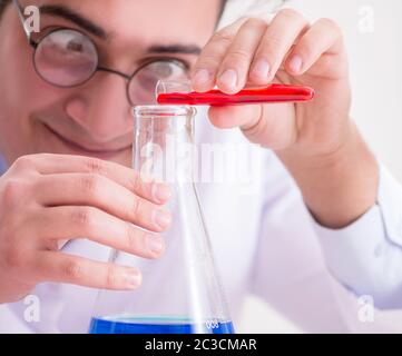 Mad crazy scientist doctor doing experiments in a laboratory Stock Photo