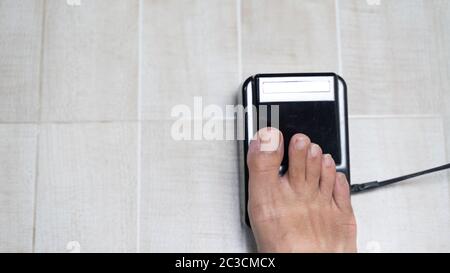 foot switch of electric sewing machine on ground floor background Stock Photo