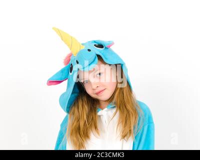 pretty blonde girl with cozy blue unicorn costume is posing in the studio in front of white wall Stock Photo