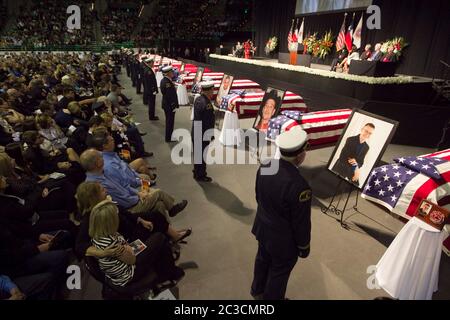 April 25, 2013 Waco, Texas USA: Honor guard members stand in front of flag-draped coffins as thousands of mourners attend a memorial for firefighters killed in the West, Texas, fertilizer plant explosion on April 17. Twelve of the 15 people killed were first responders.  ©Marjorie Kamys Cotera/Daemmrich Photography Stock Photo