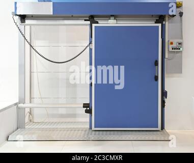 Insulated automated blue door at reefer refrigerator Stock Photo