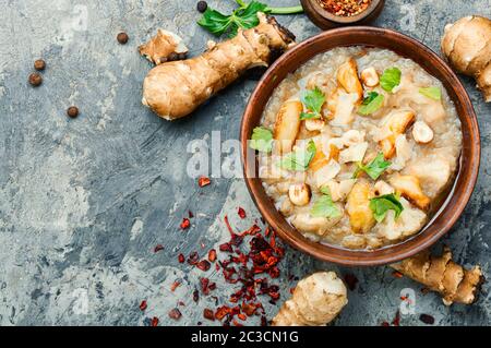 Soup of Jerusalem artichoke and cauliflower.Vegan cream soup in ceramic bowl Stock Photo