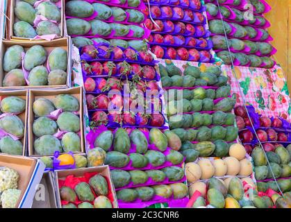 SHARM EL SHEIKH, EGYPT - NOVEMBER 22, 2019: Beautiful ripe tropical fruits : pomegranate; mango; melon on an outdoor shop, street in Egyptian city Stock Photo