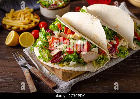 Fresch tortilla with grilled chicken, salad, eggs and cheese Stock Photo