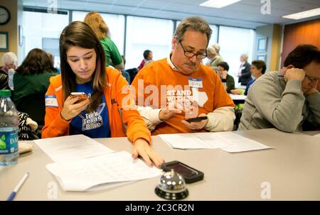 Austin Texas USA, November 23 2013: Volunteers for Battleground Texas and the state Democratic Party at a phone bank make calls to potential voters. Battleground Texas formed in 2013 and is attempting to 'turn Texas blue.' ©Marjorie Kamys Cotera/Daemmrich Photography Stock Photo