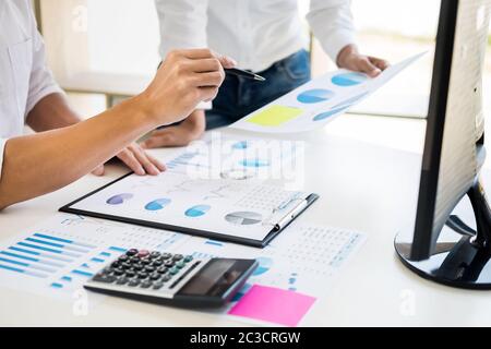 Team work process. young business managers crew working with new startup project. tablet on wood table, typing keyboard, texting message, analyse grap Stock Photo