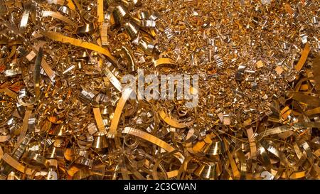 Golden background. Abstract gold background of metal shavings. Wallpaper or screensaver of yellow metallic chips. Processing of ferrous and non-ferrou Stock Photo