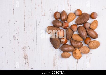 Mixed nuts on a white textured background, empty copy space Stock Photo