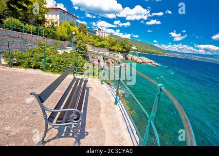 Bench by the sea on Lungomare walkway in town of Lovran Stock Photo