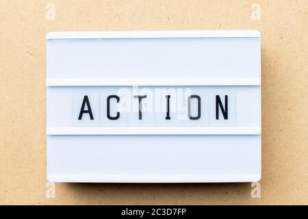 White lightbox with word action on wood background Stock Photo