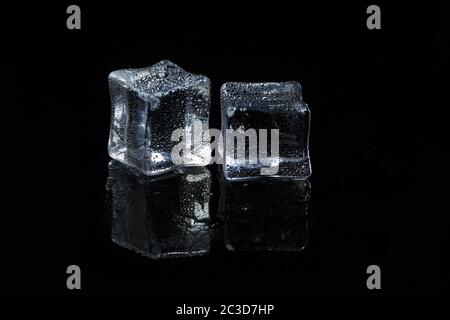 ice cubes on black isolated glass background Stock Photo