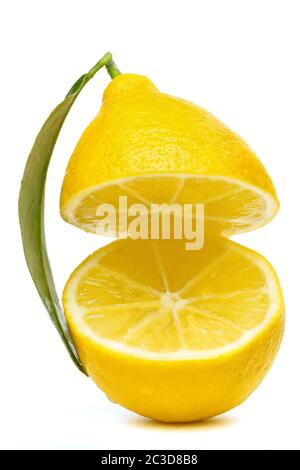 yellow lemon cut into two parts with a leaf isolated on a white background Stock Photo