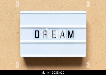 White lightbox with word dream on wood background Stock Photo