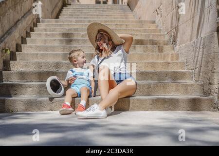 Mother and son sitting on old steps Stock Photo