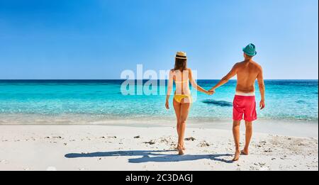 Couple walking on a tropical beach Stock Photo