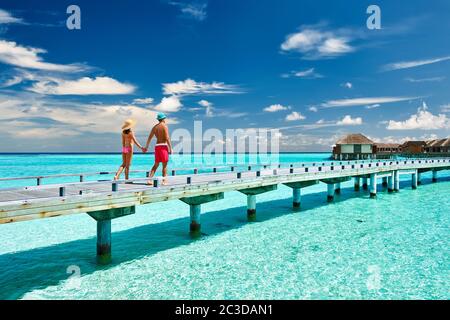 Couple on a beach jetty at Maldives Stock Photo