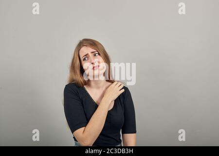 Holds the shoulder hurts, pain in my arm, sore point, problem with health care Stock Photo