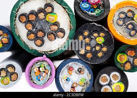 Macro photo of the cross section of various electric cables, isolated on a white background. Stock Photo