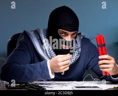 Terrorist bomber preparing dynamite bomb Stock Photo