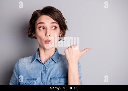 Omg incredible ads, Portrait of astonished crazy girl point forefinger copyspace direct way indicate promotion wear stylish clothes isolated over gray Stock Photo