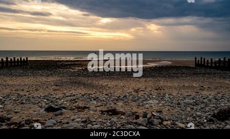 Sunset on the rocky beach, Barmouth, Wales, United Kingdom, Europe Stock Photo