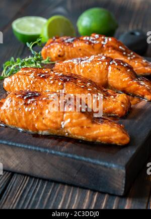 Delicious baked salmon red fish steak with spices and herbs on a dark ...