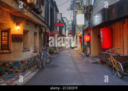 A charming and typical narrow street in the Pontocho area of downtown Kyoto, Japan at dusk. Stock Photo