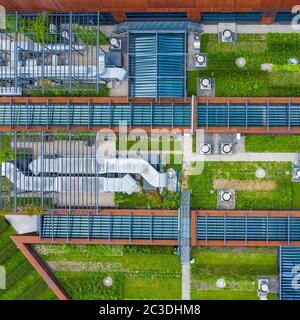 Air Condition Ventilation System Green Grass Ecology. Building Roof. Industrial Air system of ventilation and Air conditioning. Aerial Shot. Stock Photo