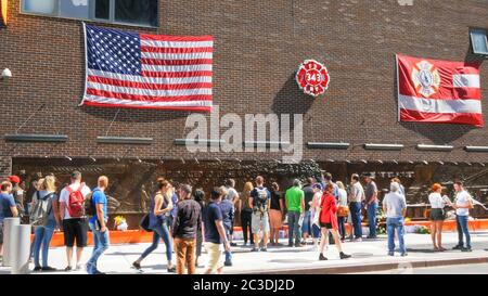 NEW YORK, NEW YORK, USA - SEPTEMBER 15, 2015: crowds at a memorial to ny fire fighters killed on sept 11 Stock Photo