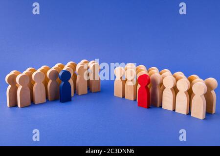 Two groups of wooden figures members participants standing behind their leaders team unity gathering deal agreement isolated over bright vivid shine Stock Photo