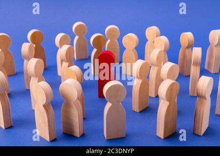 Crowd of wooden figures people walking strolling in big city. One special guy talented businessman person among strangers isolated over bright vivid Stock Photo