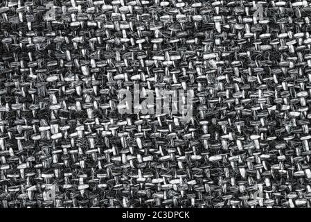 Macro shot of a white and black fabric with an interwoven pattern of horizontal and vertical lines. Stock Photo