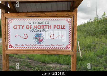 Sign welcoming visitors to North Pole, Alaska. The tiny town is home to the Santa Claus House and Shop, a popular tourist destination. Stock Photo