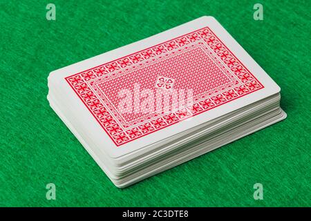 Casino playing cards on green table Stock Photo