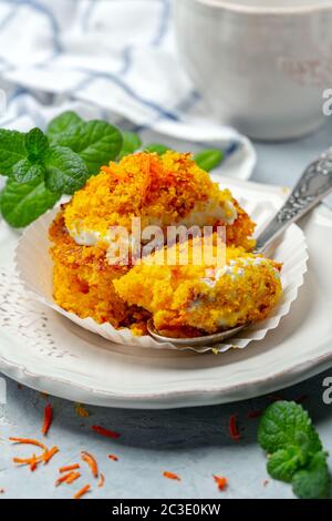 Traditional carrot cake with cream and crumbs. Stock Photo