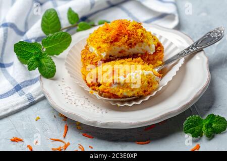 Mini carrot cake with cream and a touch of crumbs. Stock Photo