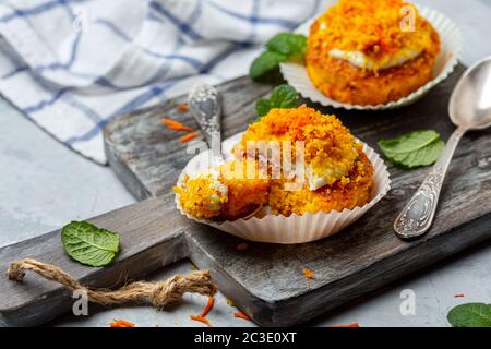 Traditional carrot mini cakes in paper capsules. Stock Photo